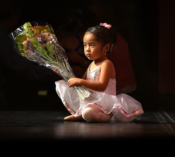 A ballerina holding flowers